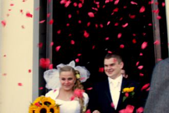 flowers thrown on bride and Groom as they exit their church wedding in poland